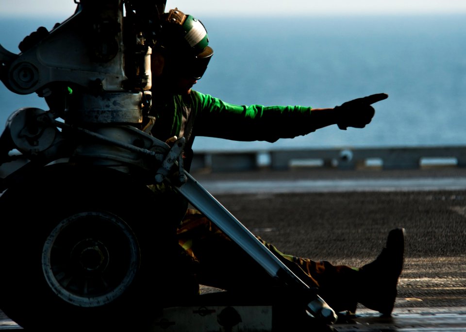 US Navy 120112-N-BT887-071 Aviation Boatswain's Mate (Equipment) 3rd Class Alfred Ranili gives the approval to add tension aboard the Nimitz-class