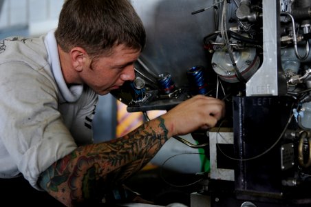 US Navy 120117-N-GZ832-001 A Sailor performs maintenance on a power plant