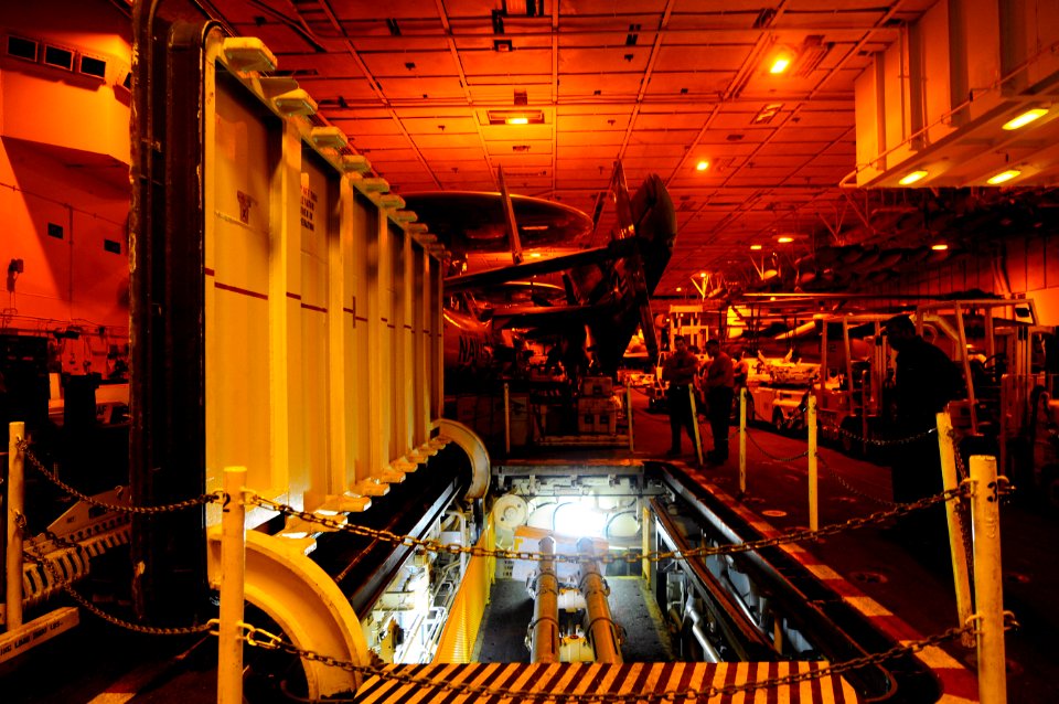US Navy 120112-N-MD252-251 Sailors move missiles into the hangar bay on a weapons elevator aboard the Nimitz-class aircraft carrier USS Carl Vinson