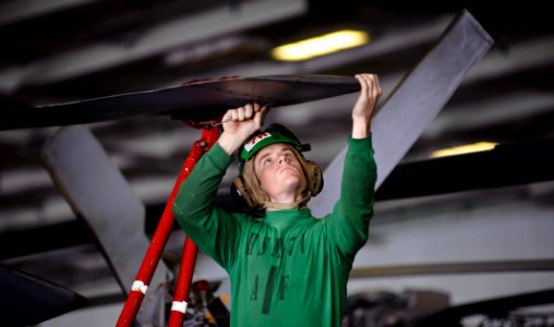 US Navy 120112-N-GC412-451 Aviation Structural Mechanic Airman Philip Alexander inspects the rotor for corrosion of an MH-60R Sea Hawk helicopter f
