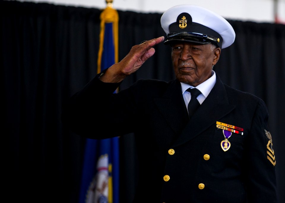 US Navy 120117-N-AC887-512 Retired Chief Petty Officer Carl E. Clark salutes Secretary of the Navy (SECNAV) the honorable Ray Mabus as he passes th