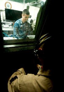 US Navy 120112-N-OY799-052 Hospital Corpsman 2nd Class Charlie Nguyen, from Fountain Valley, Calif., performs an audiogram aboard the Nimitz-class photo