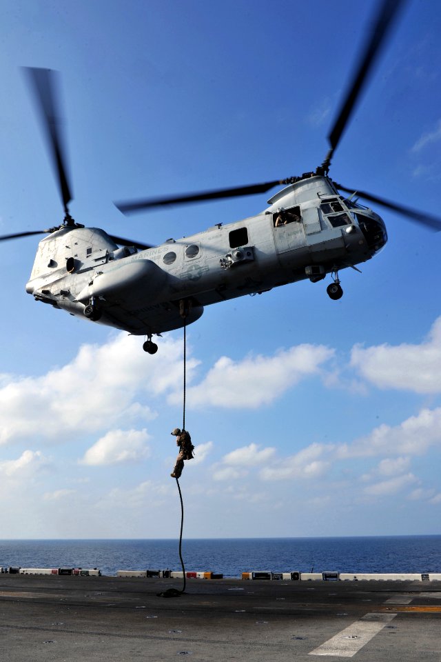 US Navy 120112-N-KD852-177 A Marine assigned to the 11th Marine Expeditionary Unit (11th MEU) fast ropes from a CH-46E Sea Knight helicopter onto t