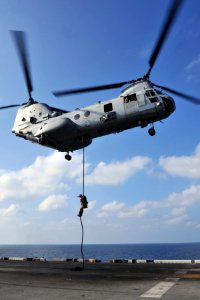 US Navy 120112-N-KD852-177 A Marine assigned to the 11th Marine Expeditionary Unit (11th MEU) fast ropes from a CH-46E Sea Knight helicopter onto t
