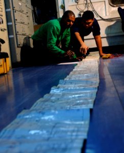 US Navy 120111-N-RG587-025 Sailors assigned to the air department aboard the Nimitz-class aircraft carrier USS Carl Vinson (CVN 70), review a schem