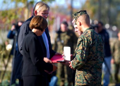 US Navy 120117-N-AC887-047 The Secretary of the Navy (SECNAV), the honorable Ray Mabus, presents the family of Lance Cpl. Donald Hogan Navy Cross d