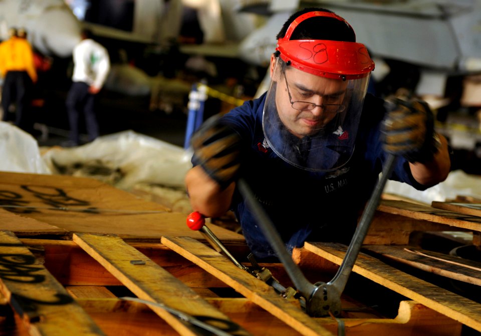 US Navy 120113-N-ZZ999-022 Machinist's Mate 1st Class David Derr prepares pallets for offload during a replenishment at sea aboard the Nimitz-class