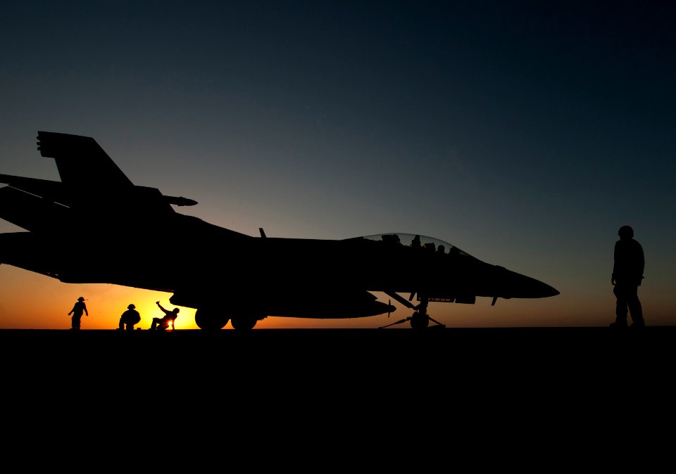 US Navy 120118-N-DR144-614 Flight deck personnel prepare to launch an F-A-18F Super Hornet assigned to Strike Fighter Squadron (VFA) 22