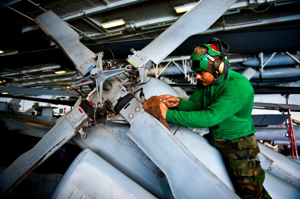 US Navy 120112-N-BT887-113 Aviation Machinist's Mate 3rd Class Felix Gonzales, from Gonzalez, Texas, cleans the tail rotor of an MH-60R Sea Hawk he