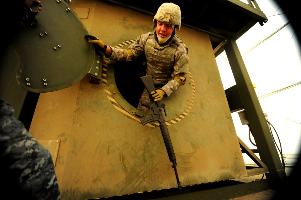 US Navy 120118-N-GO179-015 A Kandahar Role 3 Operational Medical Training Program student practices emergency exit procedures during an egress assi