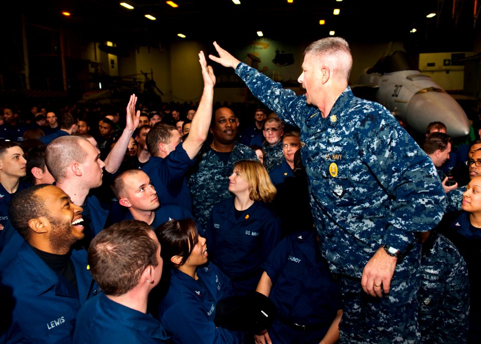 US Navy 120112-N-FI736-031 Master Chief Petty Officer of the Navy (MCPON)Rick D. West high-fives Sailors during an all-hands call aboard the aircra