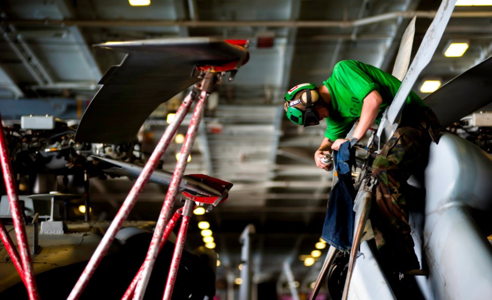 US Navy 120112-N-GC412-174 Aviation Machinist's Mate 2nd Class inspects the rotor for corrosion on an MH-60S Sea Hawk helicopter