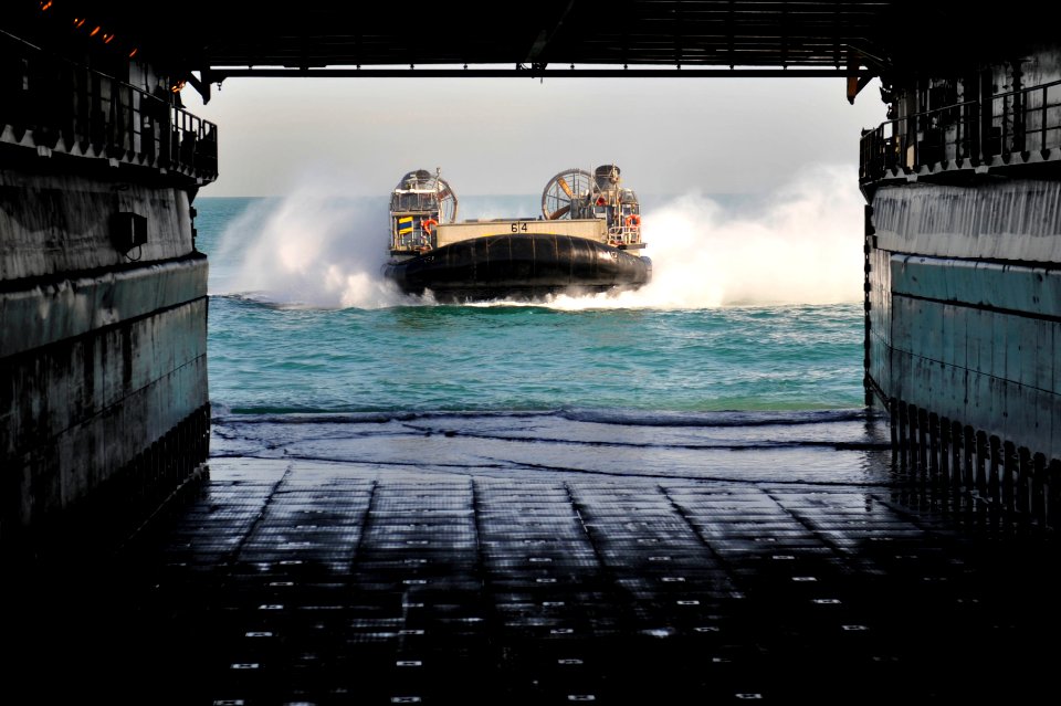 US Navy 120114-N-KS651-120 A landing craft air cushion prepares to enter the well deck of the amphibious dock landing ship USS Pearl Harbor (LSD 52