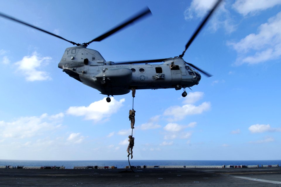 US Navy 120112-N-KD852-306 A trio of Marines assigned to the 11th Marine Expeditionary Unit (11th MEU) fast rope from a CH-46E Sea Knight helicopte