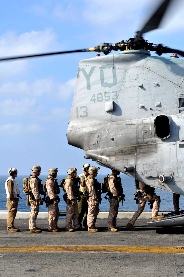 US Navy 120112-N-KD852-097 Marines assigned to the 11th Marine Expeditionary Unit (11th MEU) board a CH-46E Sea Knight helicopter on the flight dec