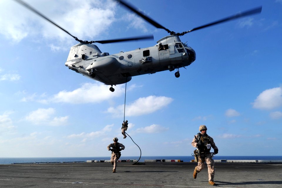 US Navy 120112-N-KD852-239 Marines assigned to the 11th Marine Expeditionary Unit (11th MEU) fast rope from a CH-46E Sea Knight helicopter onto the
