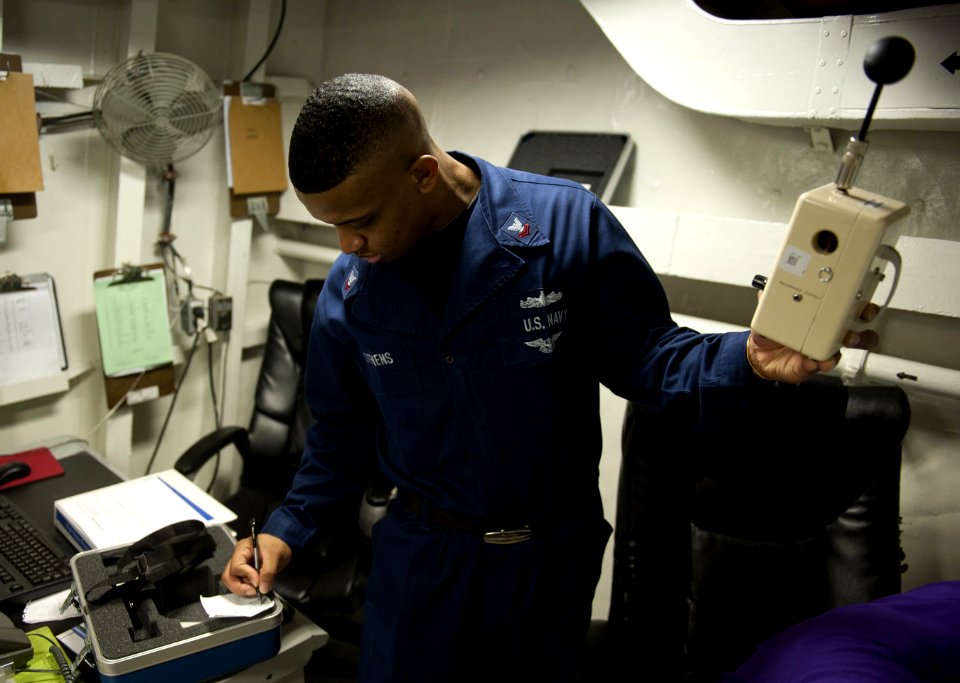US Navy 120117-N-DR144-136 A Sailor records data from a heat stress monitor to measure temperature