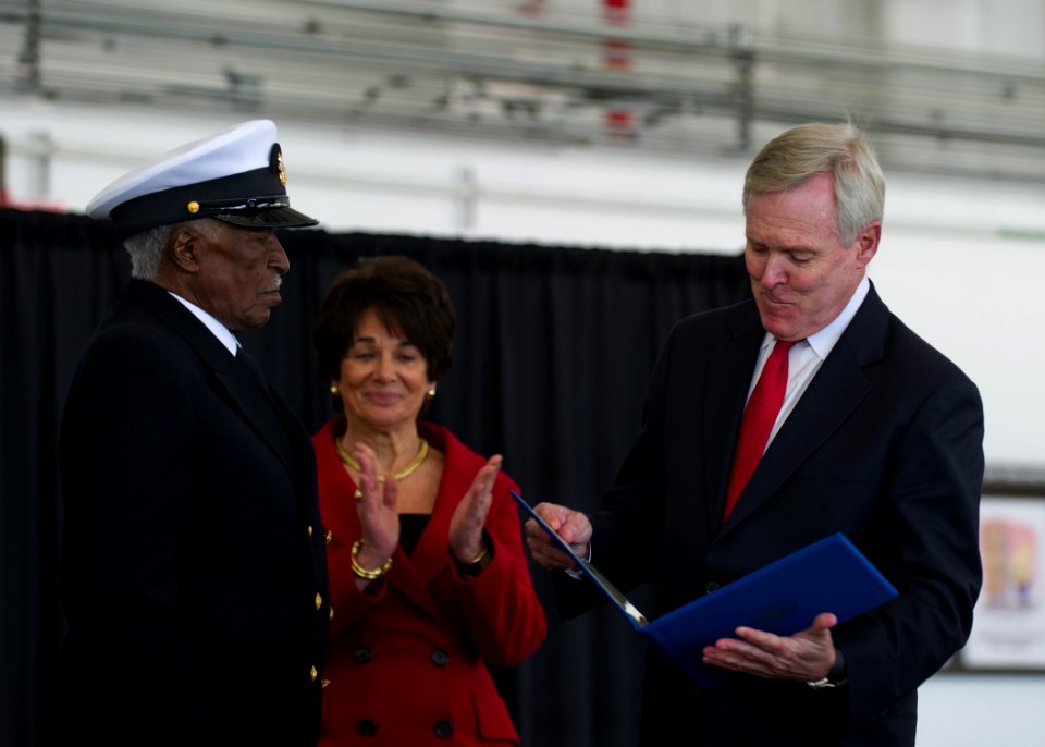 US Navy 120117-N-AC887-710 Secretary of the Navy (SECNAV) the honorable Ray Mabus presents retired Chief Petty Officer Carl E. Clark with the Navy