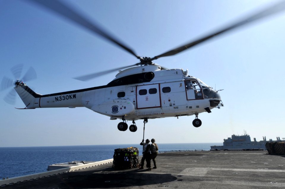 US Navy 120116-N-KD852-224 Marines assigned to Combat Cargo attach a hoist to an SA330J Puma helicopter from the Military Sealift Command dry cargo