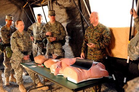 US Navy 120113-N-GO179-016 Hospital Corpsman 1st Class Lawrence Jacobs explains chest trauma procedures to members of the Kandahar Role 3 Operation photo