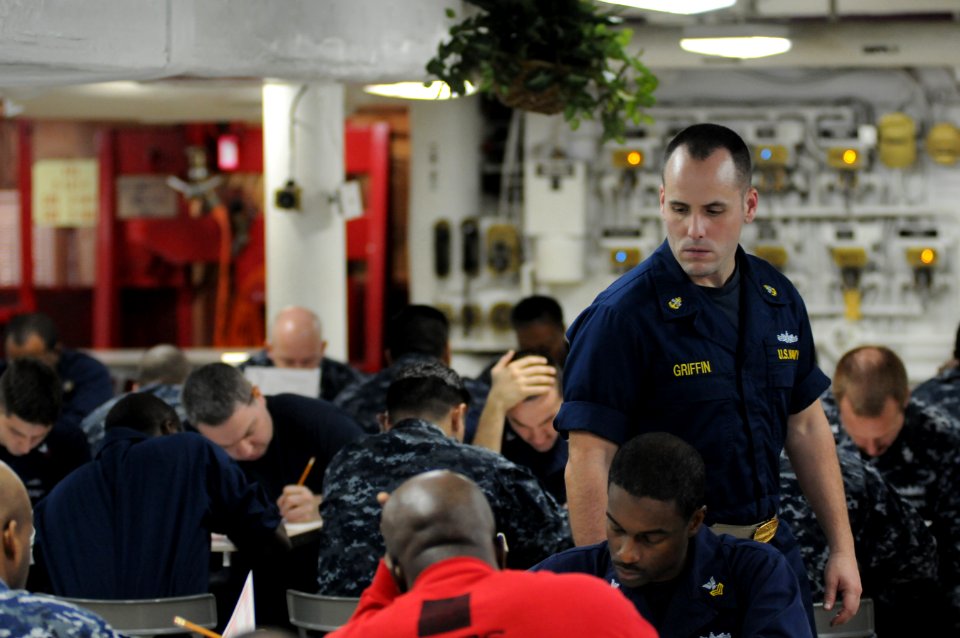 US Navy 120119-N-GZ832-006 Chief Damage Controlman Ty Griffin proctors the chief petty officer exam aboard the Nimitz-class aircraft carrier USS Ca