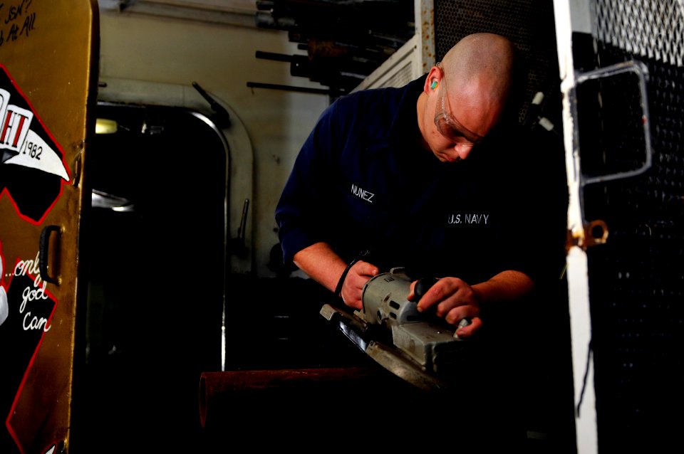 US Navy 120113-N-ZZ999-194 Hull Technician Fireman Thomas Nunez cuts a length of pipe aboard the Nimitz-class aircraft carrier USS Carl Vinson (CVN
