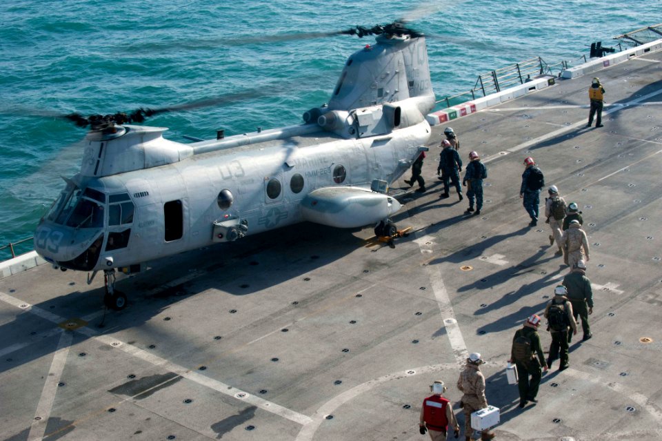 US Navy 120114-N-PB383-096 Sailors and Marines board a helicopter on the flight deck