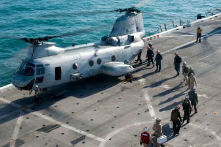 US Navy 120114-N-PB383-096 Sailors and Marines board a helicopter on the flight deck