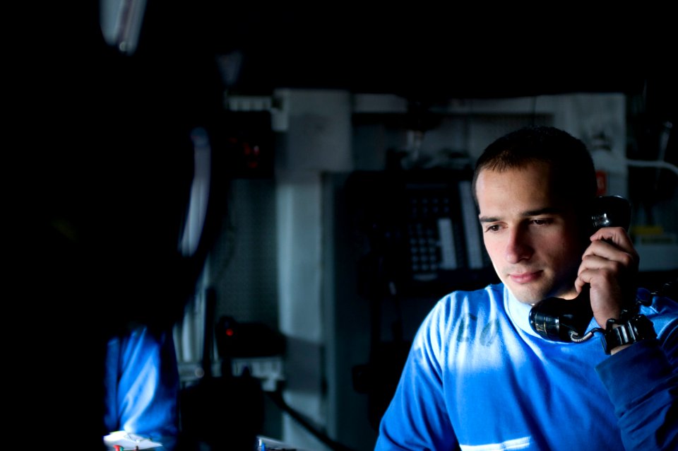 US Navy 120119-N-TZ605-072 Aviation Boatswain's Mate Airman Richard Bloom receives reports of aircraft locations while standing watch in flight dec
