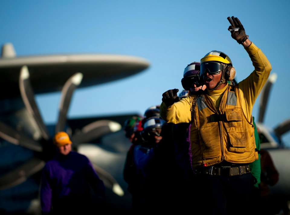 US Navy 120120-N-DR144-349 A Sailor leads a hose team during a flight deck firefighting drill