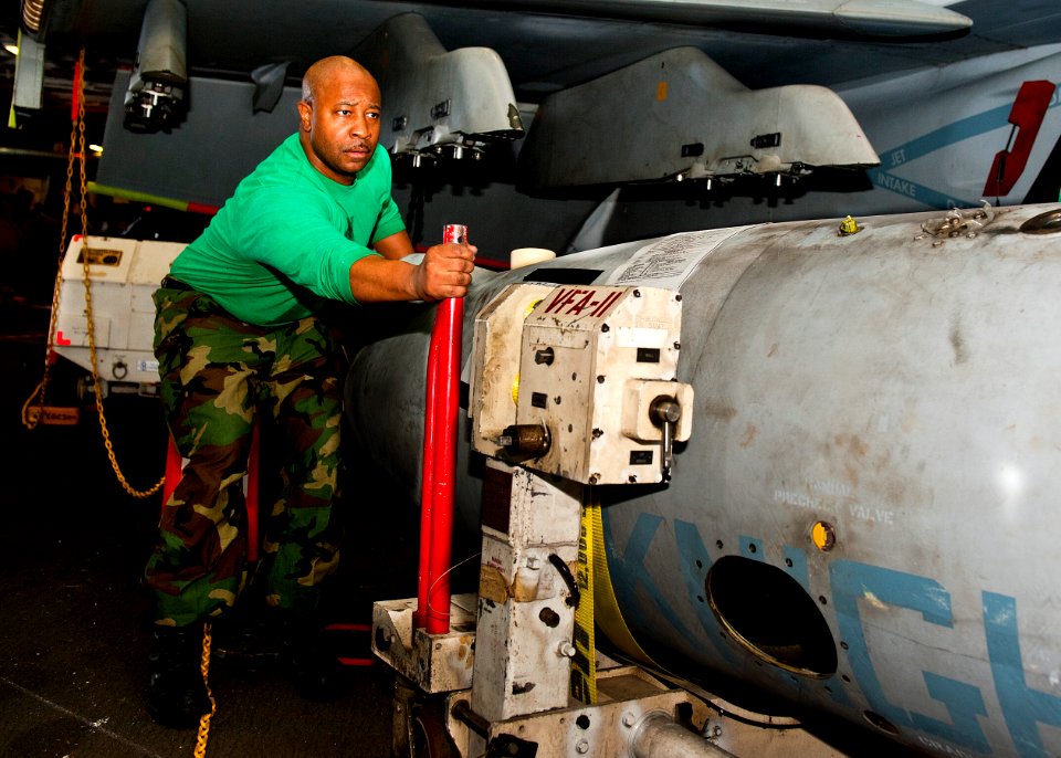 US Navy 120118-N-FI736-070 Aviation Machinist's Mate 2nd Class Shawn Mack, assigned to Strike Fighter Squadron (VFA) 136, moves an extended fuel ta