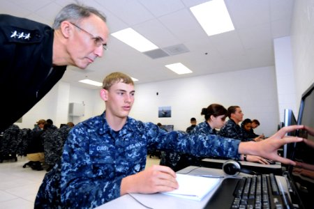 US Navy 120119-N-GS507-177 A Sailor demonstrates to Chief of Naval Personnel Vice Adm. Scott R. Van Buskirk how his computer responds to his method