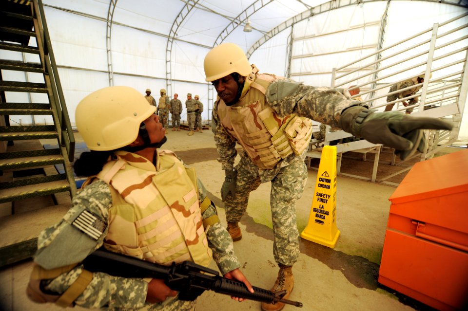 US Navy 120118-N-GO179-020 Kandahar Role 3 Operational Medical Training Program students set a perimeter during an egress assistance trainer famili