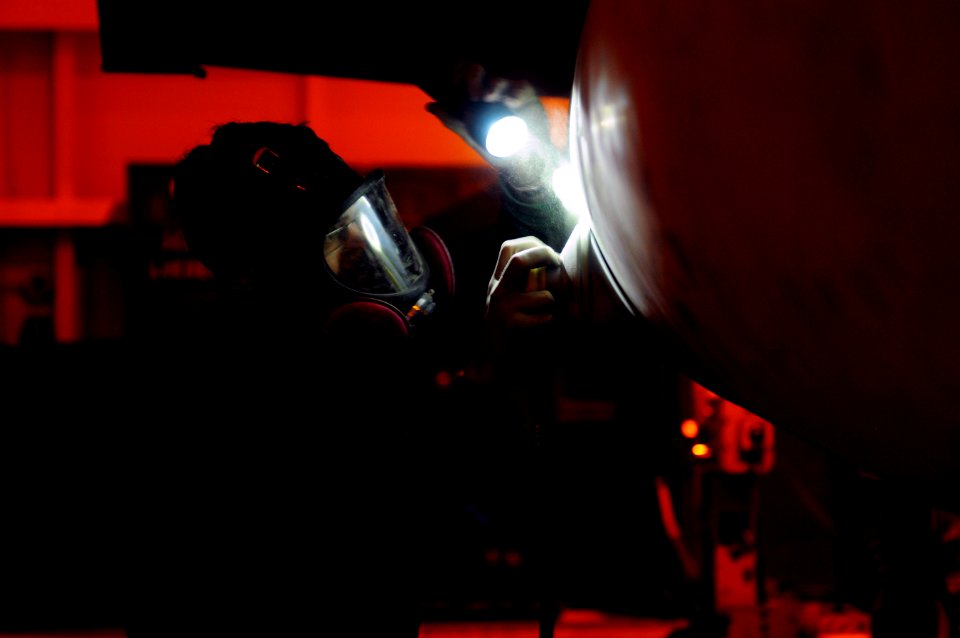US Navy 120118-N-MD252-547 Aviation Structural Mechanic Airman Michael Anger, assigned to Strike Fighter Squadron (VFA) 22, performs corrosion prev