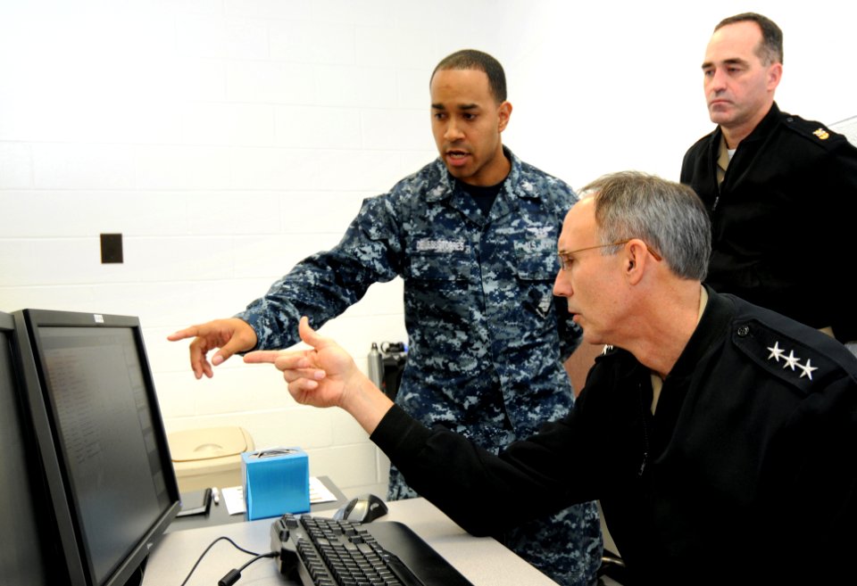 US Navy 120119-N-GS507-164 A Sailor demonstrates to Chief of Naval Personnel Vice Adm. Scott R. Van Buskirk how the experimental computer-based tea