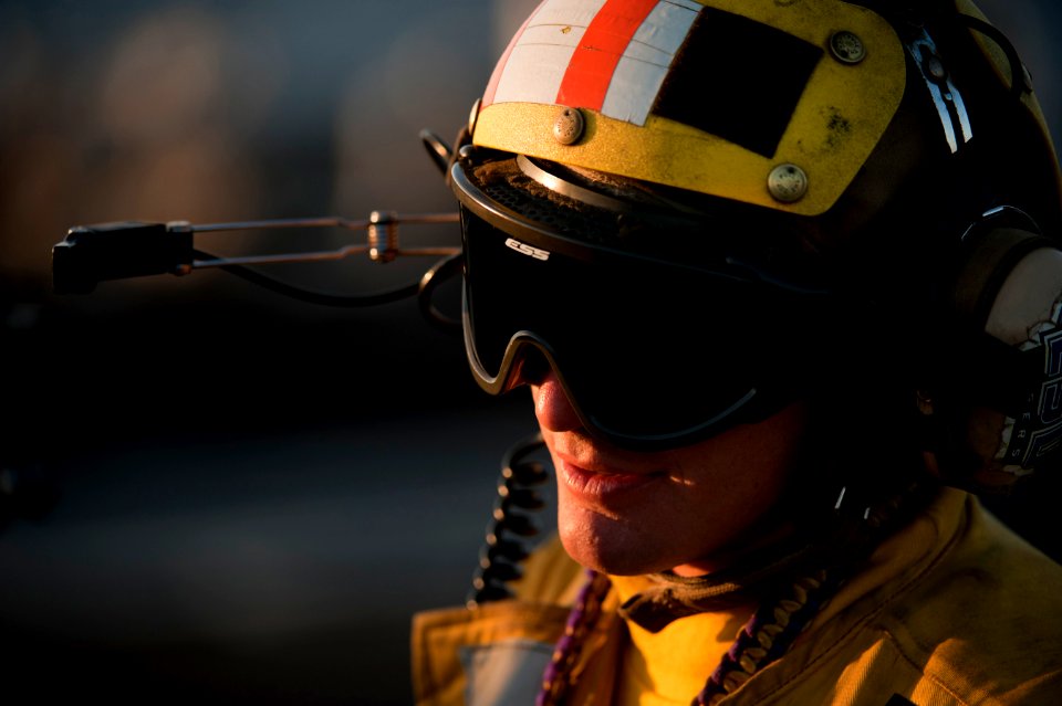 US Navy 120118-N-DR144-389 Aviation Boatswain's Mate (Handling) 2nd Class Jathan Lane works on the flight deck aboard the Nimitz-class aircraft car