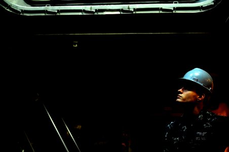 US Navy 120118-N-MD252-381 Aviation Electronics Technician Airman Christopher Fowler waits to receive aircraft electronics equipment as it is lower