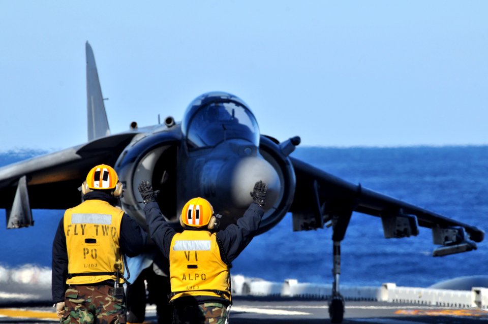 US Navy 120119-N-UM734-585 Aviation boatswain's mates direct the movement of an AV-8B Harrier from Marine Attack Squadron (VMA) 542 during flight o
