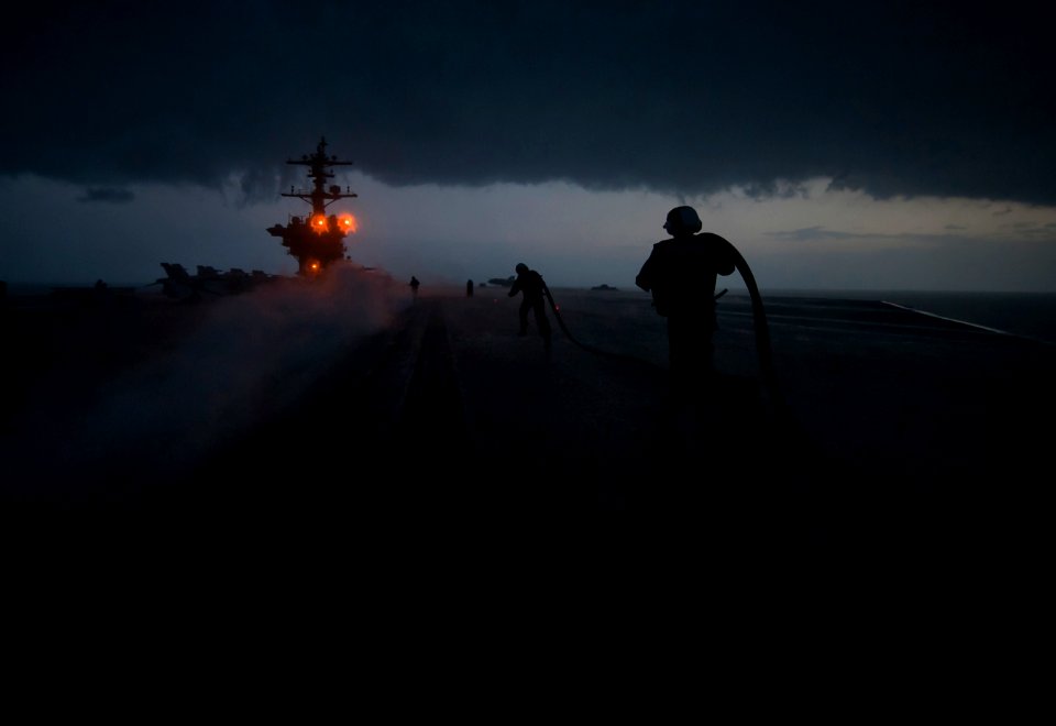 US Navy 120121-N-DR144-126 Sailors run to install slot seals in a catapult track
