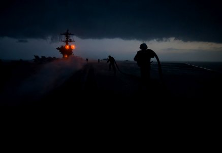 US Navy 120121-N-DR144-126 Sailors run to install slot seals in a catapult track