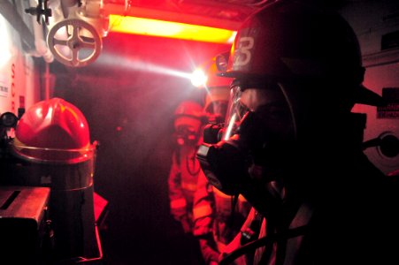 US Navy 120121-N-OP638-092 Sailors assigned to the Arleigh Burke-class guided-missile destroyer USS Porter (DDG 78) prepare to enter a smoke-filled