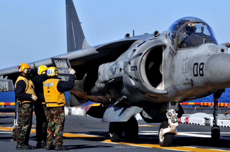 US Navy 120119-N-UM734-820 Aviation boatswain's mates show flight information to AV-8B pilot Marine Corps Capt. J.T. Widmyer, assigned to Marine At