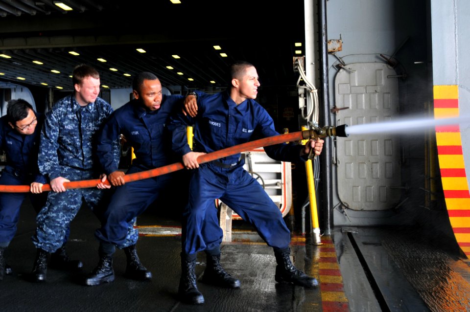 US Navy 120122-N-UM734-210 Sailors from the amphibious assault ship USS Kearsarge (LHD 3) practice fire fighting hose-handling procedures as part o