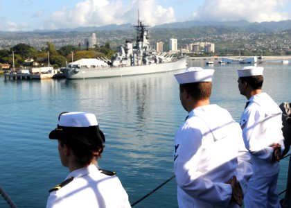 US Navy 120123-N-BK435-088 Sailors assigned to the submarine tender USS Frank Cable (AS 40) man the rails as the ship passes the historic USS Misso