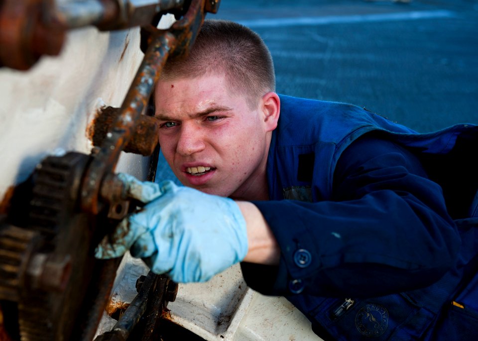 US Navy 120120-N-FI736-091 Aviation Boatswain's Mate (Handling) Airman Rob Twohill tightens the fittings of a hatch on the flight deck of the aircr
