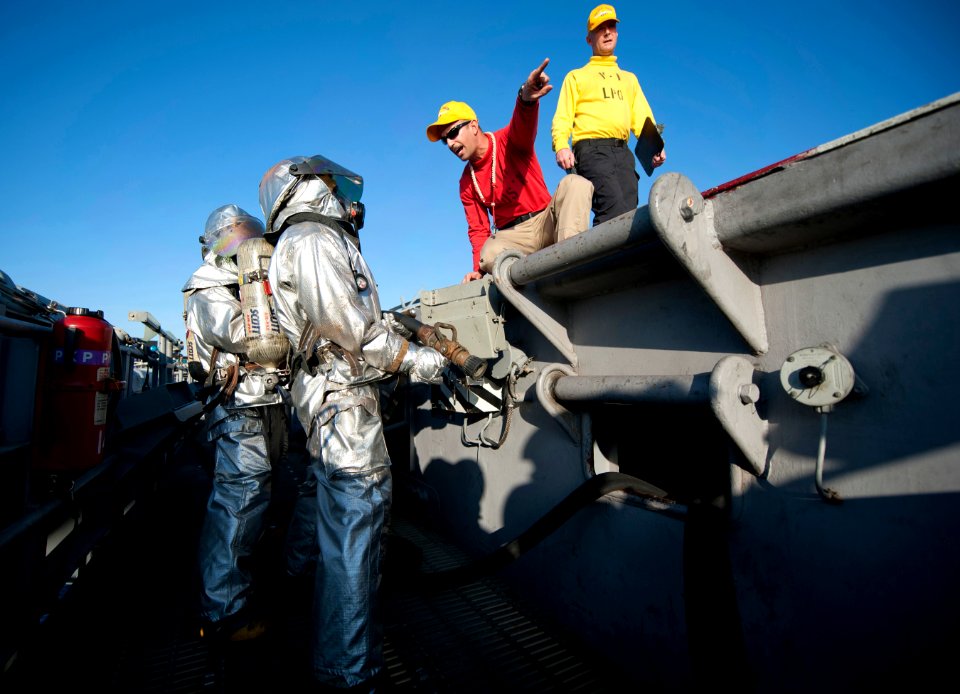 US Navy 120120-N-DR144-289 Air Boatswain Lt. j.g. Alexey Diaz trains Sailors in hot suits during a flight deck firefighting drill aboard the Nimitz