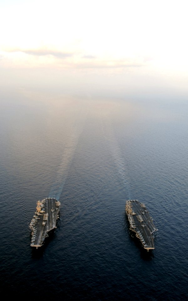 US Navy 120119-N-QH883-132 The Nimitz-class aircraft carriers USS Abraham Lincoln (CVN 72) and USS John C. Stennis (CVN 74) join for a turnover of