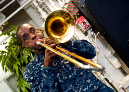 US Navy 120123-N-FI736-185 A Sailor plays trombone during a Dr. Martin Luther King, Jr. birthday celebration aboard the aircraft carrier USS Enterp