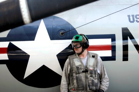 US Navy 120121-N-RG587-036 A Sailor rests against the side of a jet