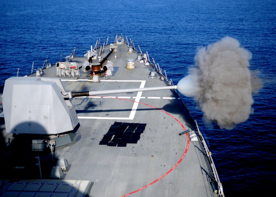 US Navy 120119-N-ZF681-334 The MK-45 5-inch-54-caliber lightweight gun aboard the guided-missile destroyer USS Halsey (DDG 97) fires